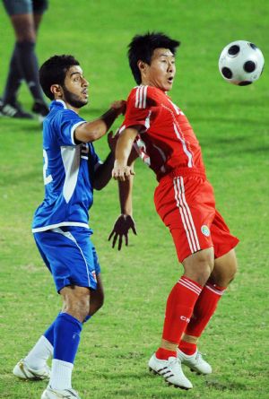 China's Jiang Ning (R) vies with Kuwait's Yakoob Thahir during a friendly football match in Kuwait City Nov. 8, 2009. The match ended with a 2-2 tie. [Noufal Ibrahim/Xinhua]