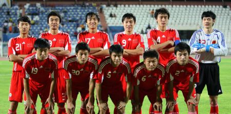 China's players pose for photos ahead of a friendly football match between China and Kuwait in Kuwait City Nov. 8, 2009. [Noufal Ibrahim/Xinhua]