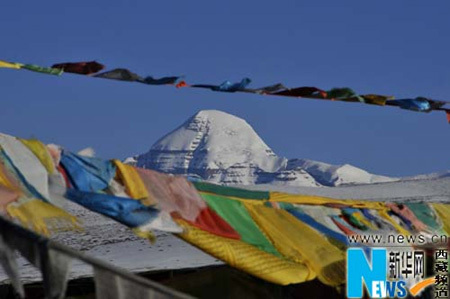Prayer streamers flutter in the wind near Mt. Kangrinboqe, considered a holy mountain for locals, in Ngari Prefecture, northern Tibet. 