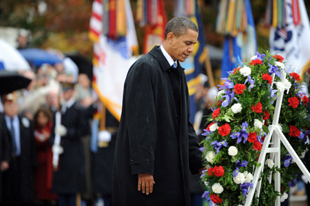 U.S. President Barack Obama takes part in a wreath laying ceremony at Arlington National Cemetery in Virginia to mark Veterans Day November 11, 2009.[Xinhua/AFP]