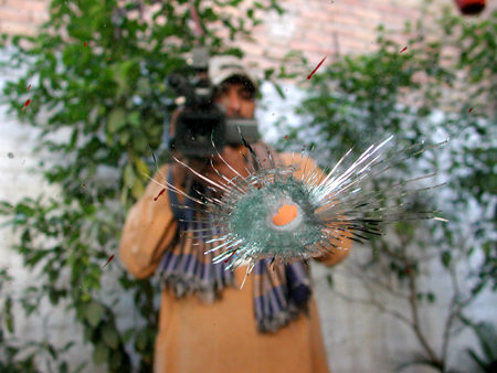Photo taken on Nov. 12, 2009 shows a bullet hole on the windscreen of the car where Syed Abul Hasan was shot dead in Peshawar, Pakistan. Syed Abul Hasan, director of public relations in the Iranian consulate in Peshawar, was shot dead in the city on Thursday. [Xinhua] 