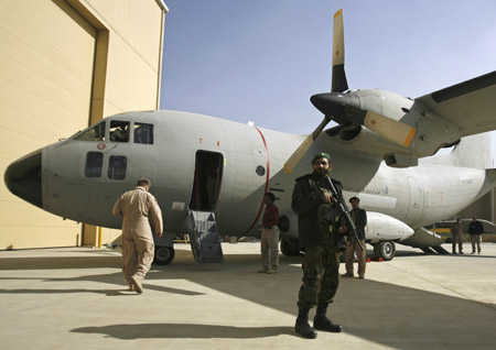 An Afghan soldier stands guard in front a C-27A transport aircraft which was given by the U.S. military, in Kabul November 15, 2009. The U.S. military will give Afghanistan 20 refurbished transport planes over the next two years, U.S. and Afghan officials said on Sunday, doubling the size of its depleted air force. [Xinhua/Reuters]