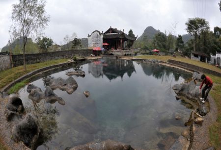 Photo taken on Nov. 15, 2009 shows a drama stage with 500 years&apos; history is reflected in water at Fuxi Village with lots of ancient architectures that date to the Ming and Qing Dynasties in Fuchuan Yao Autonomous County, southwest China&apos;s Guangxi Zhuang Autonomous Region. [Xinhua] 