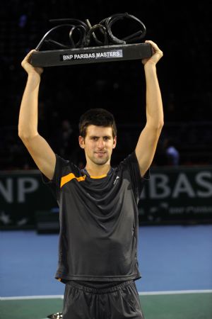 Novak Djokovic of Serbia raises his trophy during the awarding ceremony after the final of the Paris Masters Series tennis tournament against Gael Monfils of France, Nov. 15, 2009. Djokovic won the match 2-1 and claimed the title of the event. [Xinhua]