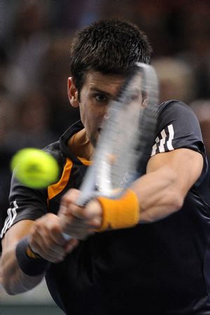Novak Djokovic of Serbia returns a shot during the final of the Paris Masters Series tennis tournament against Gael Monfils of France, Nov. 15, 2009. Djokovic won the match 2-1 and claimed the title of the event. [Xinhua]
