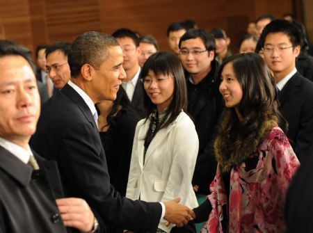 U.S. President Barack Obama shakes hands with Chinese students after having a dialogue with Chinese youths at the Shanghai Science and Technology Museum during his four-day state visit to China, Nov. 16, 2009.(Xinhua/Rao Aimin)