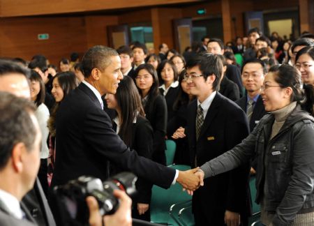 U.S. President Barack Obama shakes hands with Chinese students after having a dialogue with Chinese youths at the Shanghai Science and Technology Museum during his four-day state visit to China, Nov. 16, 2009.(Xinhua/Rao Aimin)