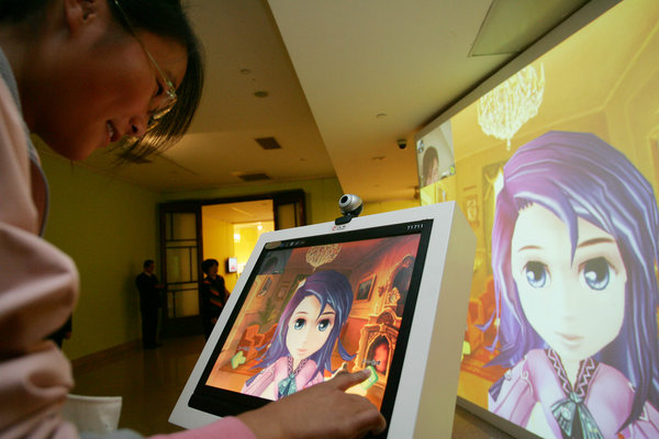 A visitor to the first animation and manga exhibition in National Art Museum of China plays with an interactive facial expression computer.