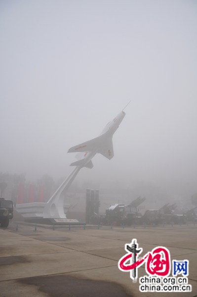 A striking J-6 fighter jet erected in the square of China Aviation Museum, flanked by missile launch vehicles that remain on active duty [Maverick Chen / China.org.cn]