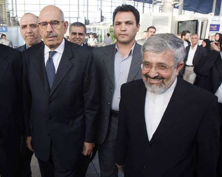 International Atomic Energy Agency IAEA Director General Mohamed ElBaradei (L) walks with Iran's Ambassador to the IAEA Ali Asghar Soltanieh (R) as he arrives at Imam Khomeini International airport, 35 km (22 miles) south of Tehran October 3, 2009.