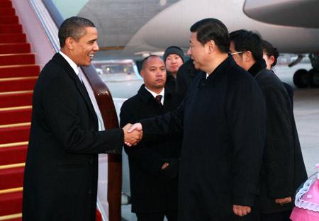Chinese Vice President Xi Jinping shakes hands with U.S. President Barack Obama at the airport in Beijing, capital of China, on Nov. 16, 2009. Obama arrived here Monday afternoon to continue his four-day state visit to China. [Xinhua] 
