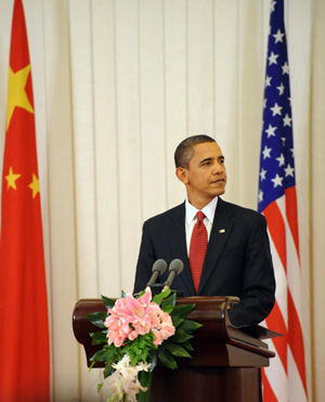 Visiting U.S. President Barack Obama reacts during a press conference held with Chinese President Hu Jintao following their official talks at the Great Hall of the People in Beijing on Nov. 17, 2009. (Xinhua/Liu Jiansheng)