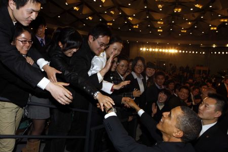 U.S. President Barack Obama shakes hands with Chinese students after having a dialogue with Chinese youths at the Shanghai Science and Technology Museum during his four-day state visit to China, Nov. 16, 2009.(Xinhua/Rao Aimin)