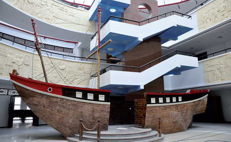 The exhibition hall with a model boat on display.
