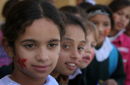 Palestinian children have their faces painted and gather to commemorate the Universal Children&apos;s Day, which falls on Friday, near their home, south of Gaza City, Nov. 19, 2009. [Xinhua]