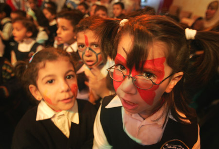 Palestinian children have their faces painted and gather to commemorate the Universal Children&apos;s Day, which falls on Friday, near their home, south of Gaza City, Nov. 19, 2009. [Xinhua]