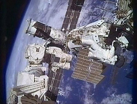 This NASA TV image shows Atlantis astronaut Robert Satcher on the robotic arm, working during a planned spacewalk November 19, 2009. [Xinhua/AFP ]