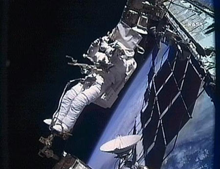 This NASA TV image shows Atlantis astronaut Robert Satcher on the robotic arm, working during a planned spacewalk November 19, 2009. [Xinhua/AFP ]