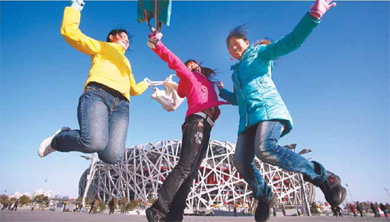 How blue is my sky! Three women seem to dwarf the Bird's Nest as they enjoy the winter sunshine and the blue sky on Friday. Beijing experienced its 260th blue-sky day in 2009 on Friday, reaching its target 41 days before the end of the year. [Wang Jing/China Daily]