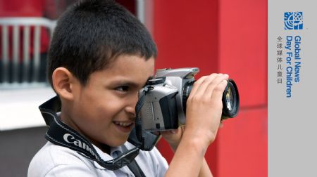 Eduardo Loayza takes photo with his camera in Panama, Oct. 23, 2009. Nine-year-old Eduardo Loayza is a third grade pupil whose father is a taxi driver. He fell in love with photography the first time he put hands on a camera. On Nov. 4, the Panama's Flag Day, he took his camera to shoot the parade. He wishes to be a photographer when he grows up. (Xinhua/Wang Pei)