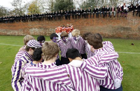 The Collegers (L) and the Oppidans prepare for the Eton Wall Game at Eton college in Eton November 21, 2009. Originating in 1766, the game is played on a narrow strip 110 metres long up against a wall. The idea is to move the ball along the wall with your feet and score a goal at the far end. Goals are very rare, the last one scored was a hundred years ago in 1909.(Xinhua/Reuters Photo)