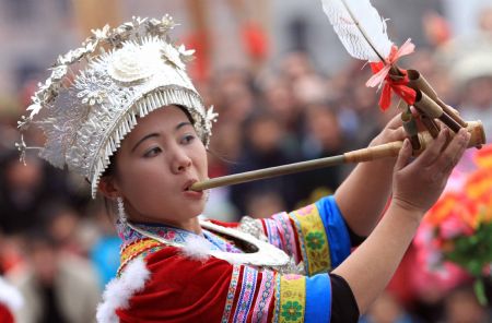 A girl of the Miao ethnic group performs lusheng dance during the Lusheng and Horse Fight Festival held in the Sports Park in Rongshui Miao Autonomous County, southwest China's Guangxi Zhuang Autonomous Region, Nov. 21, 2009.(Xinhua/Long Tao)