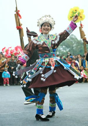 A girl of the Miao ethnic group performs lusheng dance during the Lusheng and Horse Fight Festival held in the Sports Park in Rongshui Miao Autonomous County, southwest China's Guangxi Zhuang Autonomous Region, Nov. 21, 2009. (Xinhua/Long Tao)