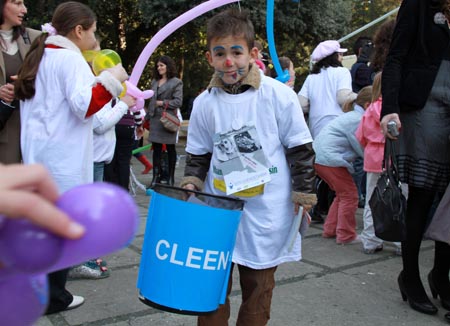 A boy picks up junk into a waste bin during a celebration marking the 20th anniversary of the Convention on the Rights of the Child in Tirana, capital of Albania, Nov. 21, 2009. Albanian President Bamir Topi and his wife as well as foreign diplomats joined groups of children in the activity here Saturday. The U.N. General Assembly adopted the Convention on the Rights of the Child on Nov. 20, 1989. (Xinhua/Yang Ke)