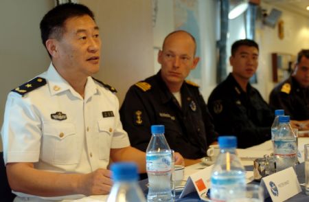 Wang Zhiguo (L), commander of the Chinese naval 3rd escort fleet, talks with officials of the European Union (EU) navy 465 formation during his visit to the Dutch frigate "Eversten" at the invitation of the European Union (EU) navy 465 formation in the Gulf of Aden, Nov. 22, 2009. (Xinhua/Guo Gang)