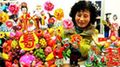 A folk craftswoman arranges dough figurines at 2009 Lianyungang Culture Expo in Lianyungang, a city of east China's Jiangsu Province, Nov. 22, 2009. (Xinhua/Wang Chun)