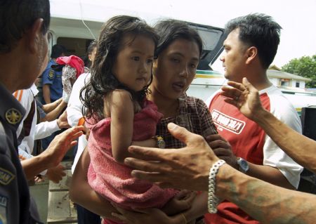 A mother and her daughter arrive in port after being rescued from a sunken ferry off Karimun island, Riau province November 22, 2009.