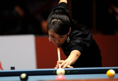 Pan Xiaoting of China hits the ball during the third-place match against her compatriot Fu Xiaofang at the 2009 Women's 9-Ball World Championship in Shenyang, northeast China's Liaoning Province, Nov. 22, 2009. Pan won 9-1. (Xinhua/Li Gang)