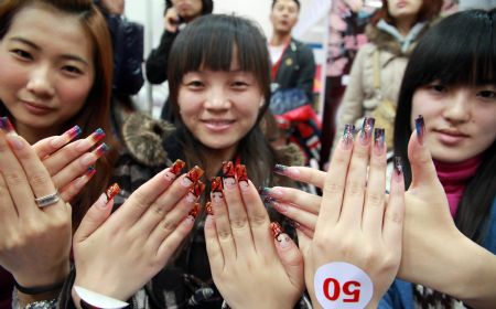A bevy of model shows off their beautifully-manicured lustrous gel nails with innovative patterns, at the 2009 China International Beautiful Manicure Art Festival, concurringly the Beautiful Manicure Match, in the Ditan Gynamsium of Beijing, Nov. 22, 2009. (Xinhua/Chen Xiaogen) 
