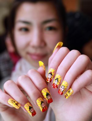 A model shows off her beautifully-manicured nails with innovative pattern, at the 2009 China International Beautiful Manicure Art Festival, concurringly the Beautiful Manicure Match, in the Ditan Gynamsium of Beijing, Nov. 22, 2009. (Xinhua/Chen Xiaogen)
