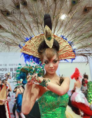 A model shows off her beautifully-manicured nails with innovative pattern and docoration, at the 2009 China International Beautiful Manicure Art Festival, concurringly the Beautiful Manicure Match, in the Ditan Gynamsium of Beijing, Nov. 22, 2009. (Xinhua/Chen Xiaogen) 