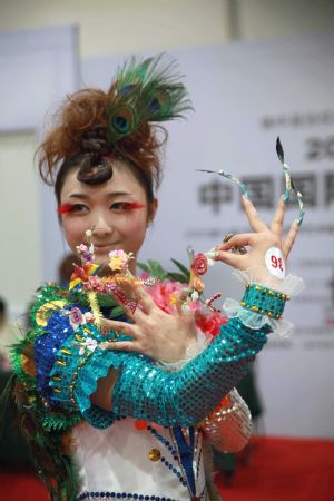 A model shows off her beautifully-manicured nails with innovative pattern and docoration, at the 2009 China International Beautiful Manicure Art Festival, concurringly the Beautiful Manicure Match, in the Ditan Gynamsium of Beijing, Nov. 22, 2009. (Xinhua/Chen Xiaogen)