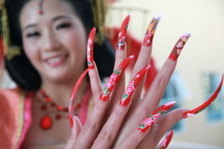 A model shows off her beautifully-manicured nails with innovative pattern, at the 2009 China International Beautiful Manicure Art Festival, concurringly the Beautiful Manicure Match, in the Ditan Gynamsium of Beijing, Nov. 22, 2009. (Xinhua/Chen Xiaogen)
