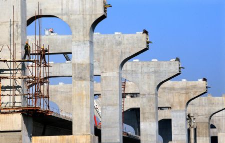 The Zhengzhou Yellow River highway and railway dual-use bridge is almost finished in central China's Henan Province, on Nov. 22, 2009. The bridge is expected to be completed in July 2010 and open to traffic in the end of October 2010. The bridge, connecting Zhengzhou and Xinxiang of Henan Province, serves as the longest (9,177 meters) huge-sized highway and railway dual-use bridge over the Yellow River, with the highest designed railway speed of 350 kilometers per hour. (Xinhua/Wang Song)