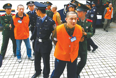 Gang suspects are escorted to court for a trial on Nov 6 in Chongqing. China Daily