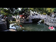 Tongli is an ancient water town in east China's Jiangsu Province. A short drive from Suzhou, Tongli offers a step back in time. Crisscrossed by rivers and canals. Tongli enjoys fame across China for its beautiful rivers, historic bridges and opulent court yard homes. Tongli has 49 stone bridges and many gardens, temples. Because of the landscape, almost all of the buildings are constructed along the waterfront. [Photo by Liu Guoxing]