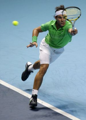 Rafael Nadal of Spain returns the ball to Robin Soderling of Sweden during their ATP World Tour Finals first round tennis match in London November 23, 2009.