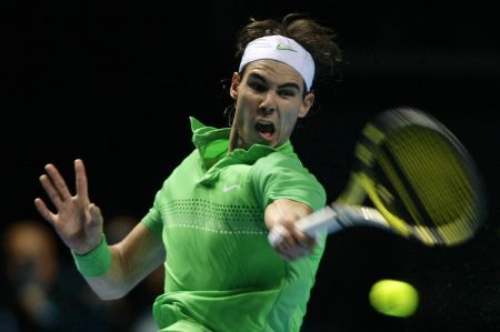Rafael Nadal of Spain returns the ball to Robin Soderling of Sweden during their ATP World Tour Finals first round tennis match in London November 23, 2009.