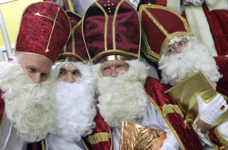 Men dressed as Santa Claus pose in the assembly hall after a meeting of the rent-a-Santa Claus service organised by the 