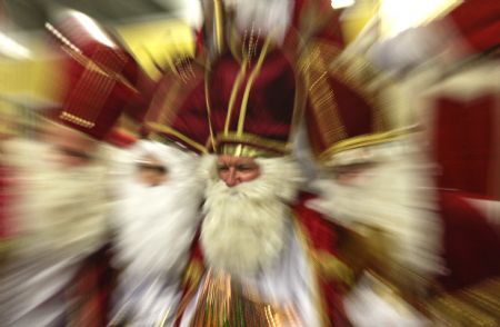 Men dressed as Santa Claus pose in the assembly hall after a meeting of the rent-a-Santa Claus service organised by the "jobcafe.de" at Munich