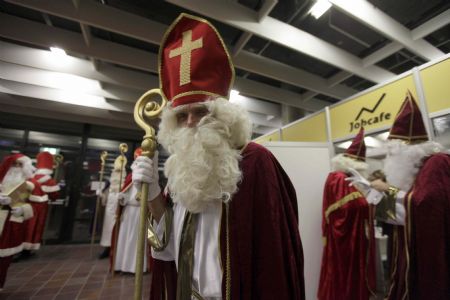 Men dressed as Santa Claus pose in the assembly hall after a meeting of the rent-a-Santa Claus service organised by the "jobcafe.de" at Munich