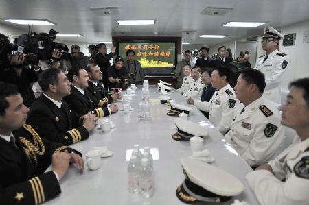 Rear Admiral Wang Fushan (3rd R), deputy commander of the Chinese Navy North Sea Fleet, holds talks with Chilean navy officers on Chinese navy missile destroyer Shijiazhuang at the harbor in Valparaiso, Chile, Nov. 23, 2009.(Xinhua/Jorge Villegas)