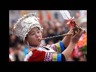 A Miao ethnic girl dances during the 4th Lusheng and Horse Fight Festival in the Sports Park in Rongshui Miao Autonomous on November 21 in Rongshui, Guangxi Zhuang Autonomous Region of China.(China.org.cn / CFP)