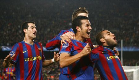 Barcelona's Pedro Rodriguez (C) celebrates with teammates Dani Alves (R) and Sergio Busquets after scoring against Inter Milan during their Champions League soccer match at Nou Camp stadium in Barcelona November 24, 2009.