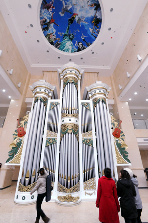 Junior students admire a huge pipe organ at the Shenyang Conservatory of Music in northeast China's Liaoning Province on Nov. 24, 2009. The newly-installed organ with a height of nine metres and weight of seven tons are made of about 2,000 pipes, among which are 60 wood pipes and over 1,900 metal pipes.