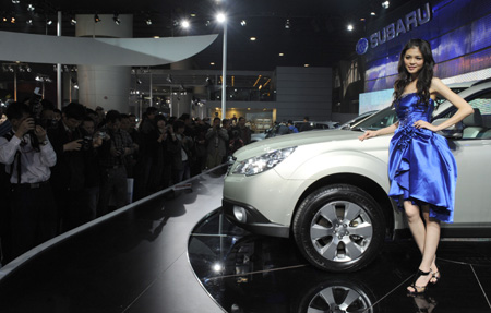  A model stands next to a SUBARU car during the 7th Guangzhou International Auto Show opened in Guangzhou, south China's Guangdong Province, Nov. 24, 2009. Some 720 automibles from over 60 auto makers are on show.